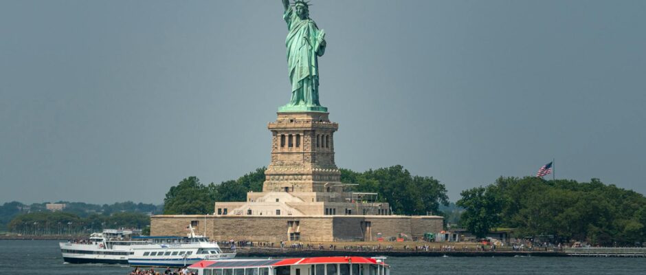 Statue of Liberty with a tour boat in the foreground.