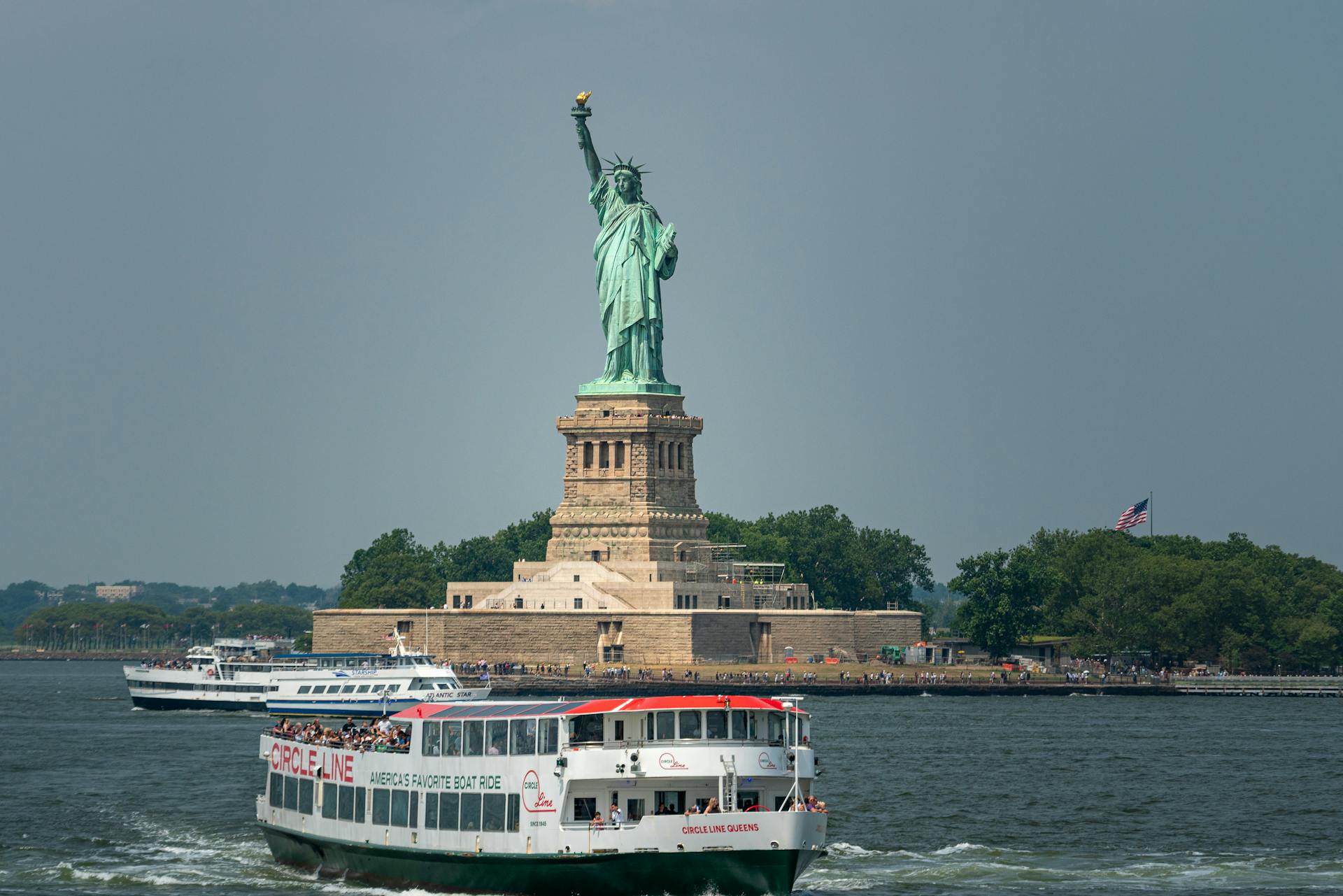Statue of Liberty with a tour boat in the foreground.