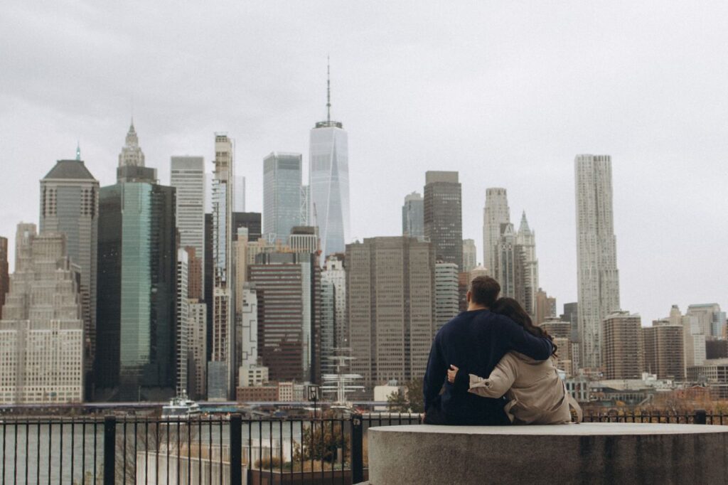 Couple embracing while looking at the New York City skyline.
