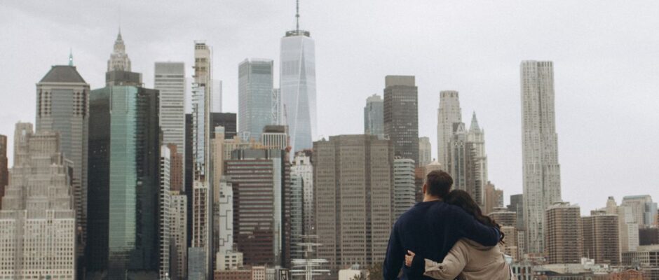 Couple embracing while looking at the New York City skyline.